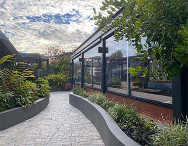 Dark Ziptrak blinds enclosing courtyard garden at Perth residential property