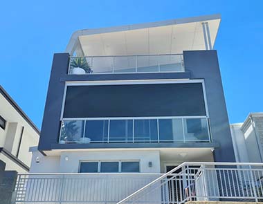 Multistorey house with dark ziptraks over balcony from Kenlow