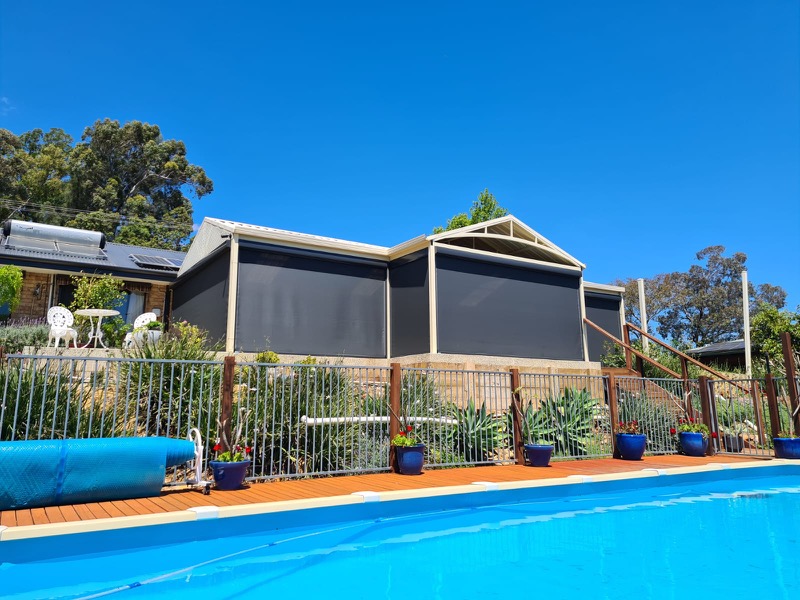 Kenlow home exterior black outdoor blinds in pool area